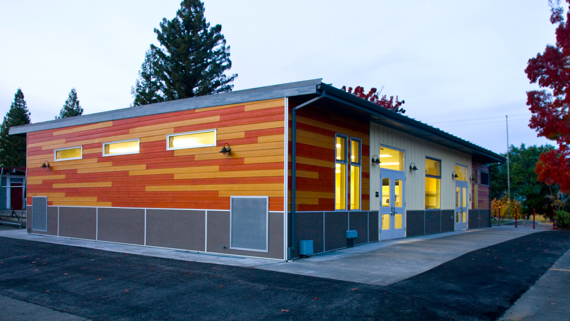 New multi-use room exterior, with wooden panel walls over gray wainscot.