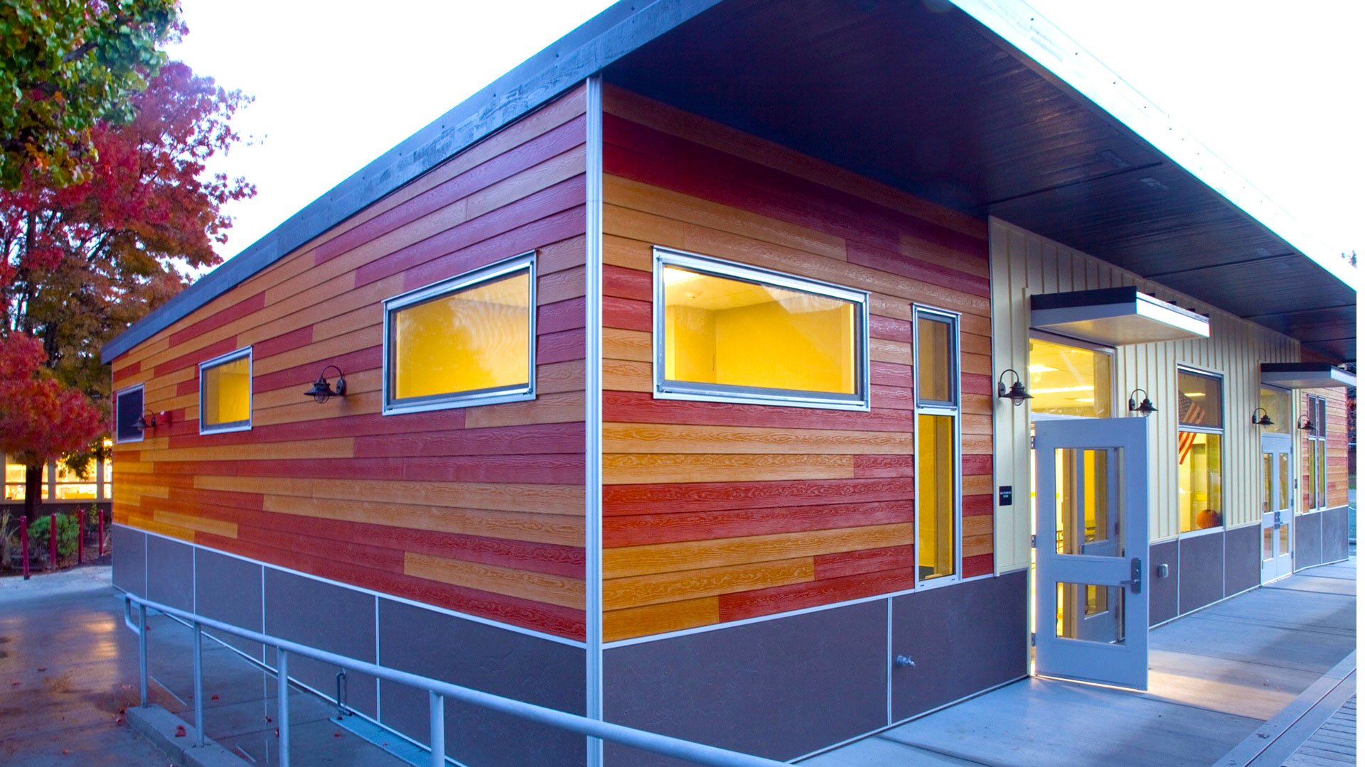 New multi-use room exterior, with wooden panel walls over gray wainscot.