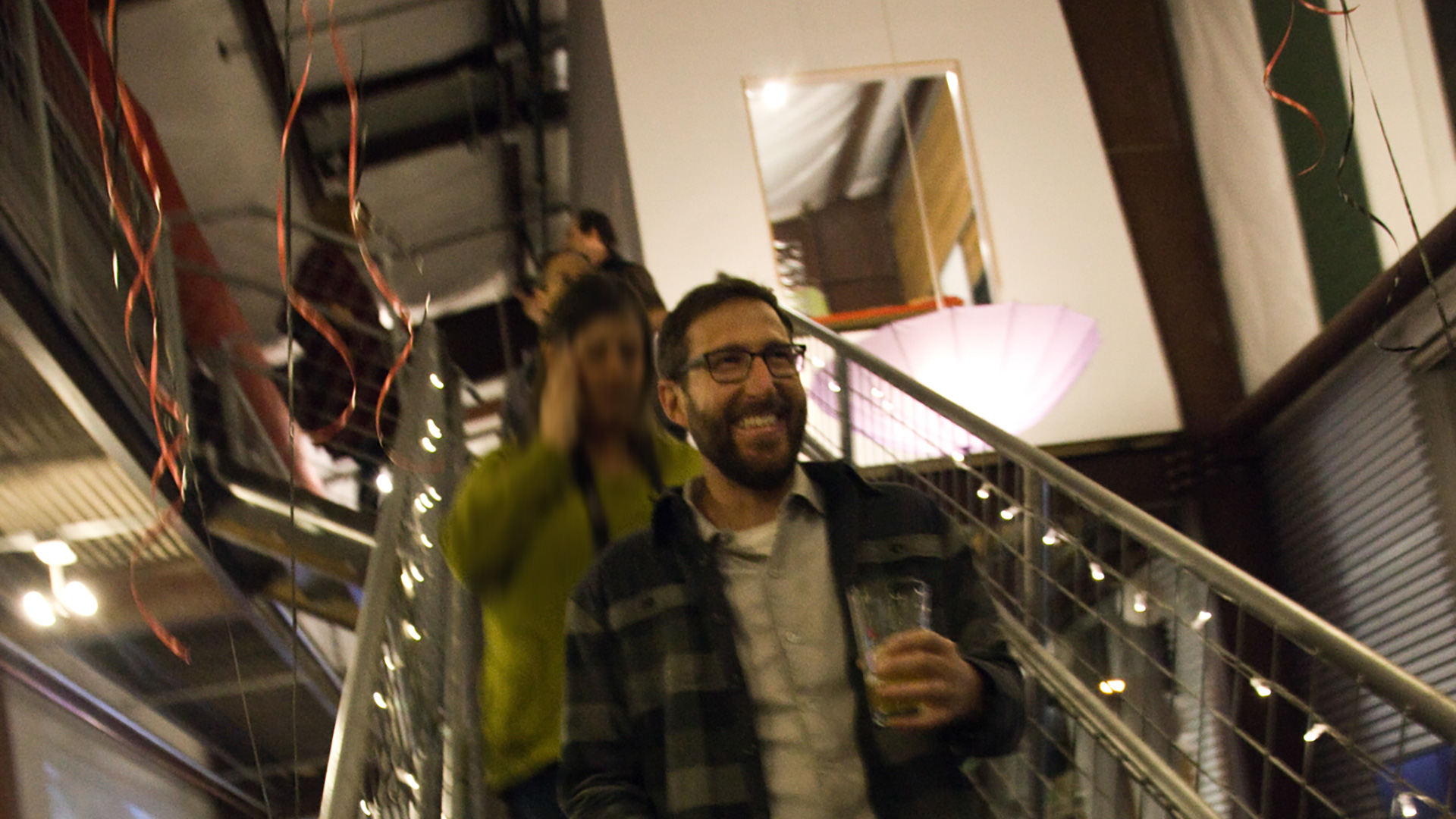 Smiling people walking down staircase