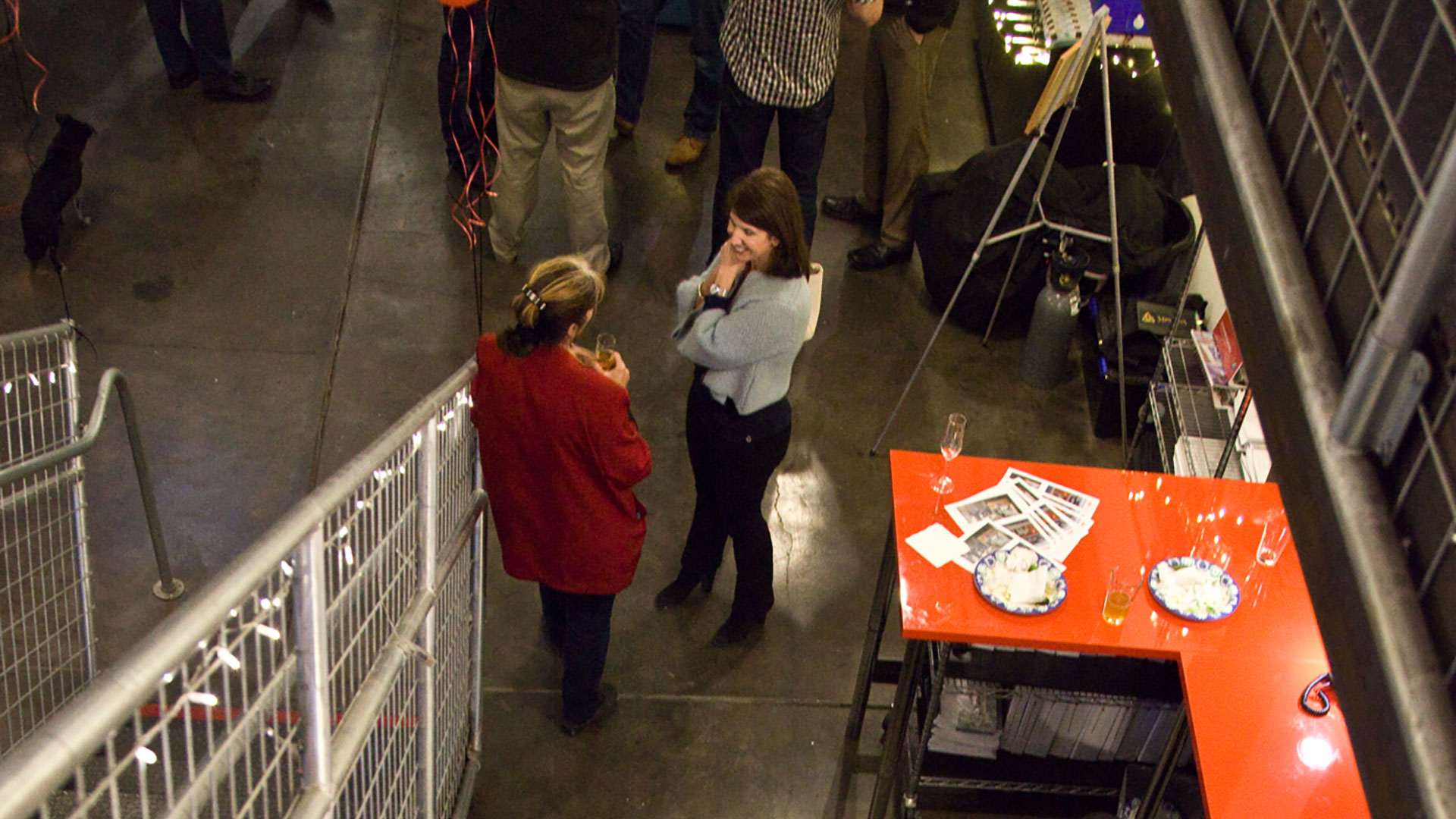 Upper view looking down at people chatting in Persinger Architects office