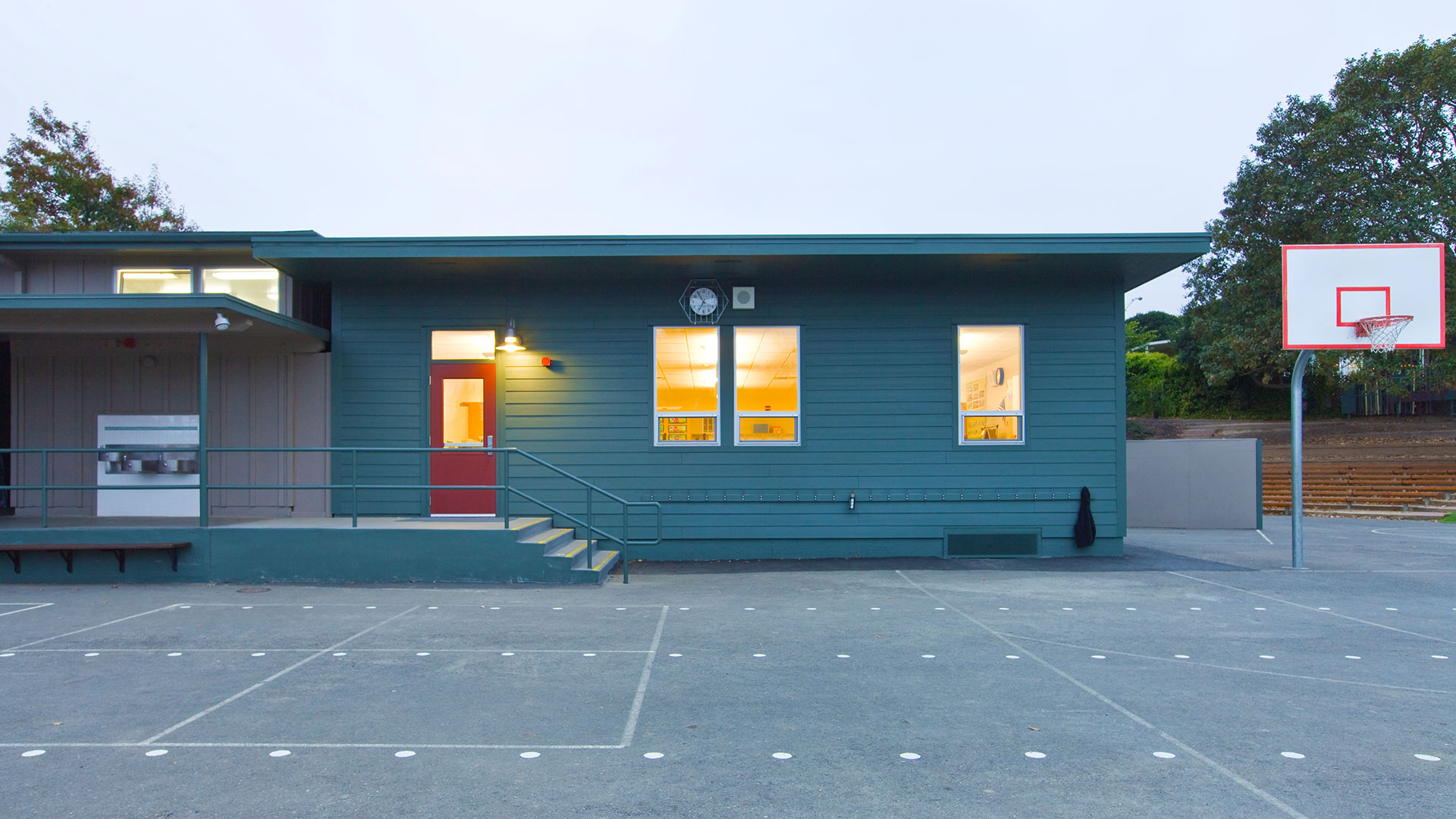 New portable classroom building with blue walls and a orange door.