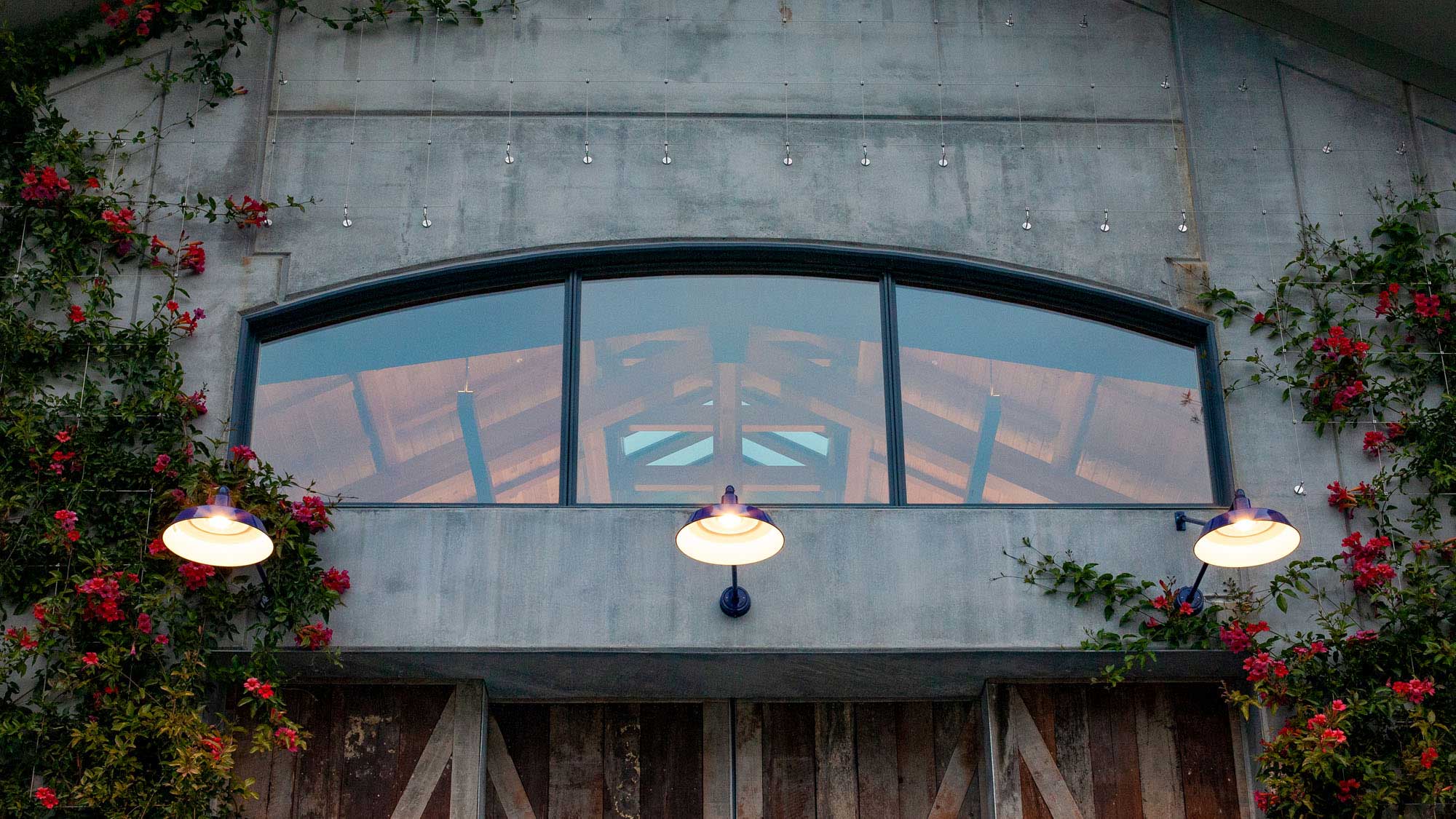 front-facing close-up of window above front door, showing hints of the trusses behind.