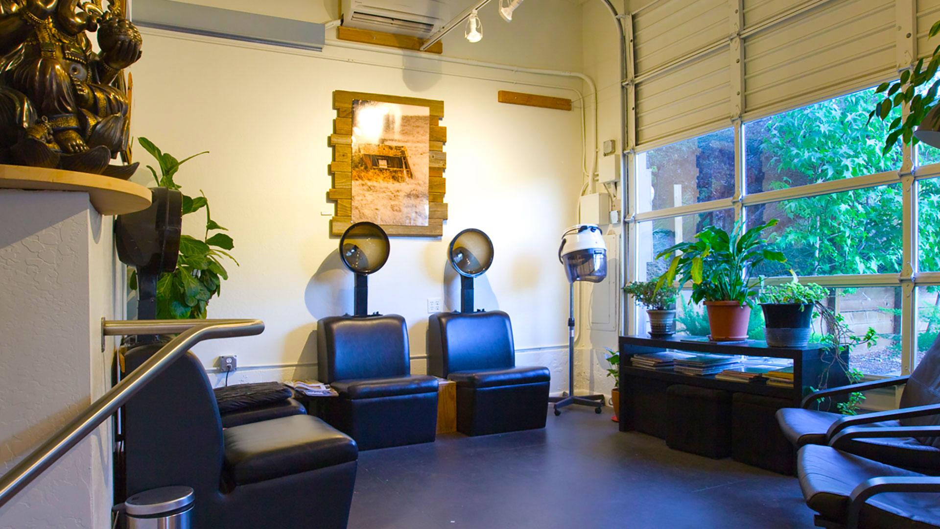 Hair drying seats at end of building, with windows and garage doors on side.