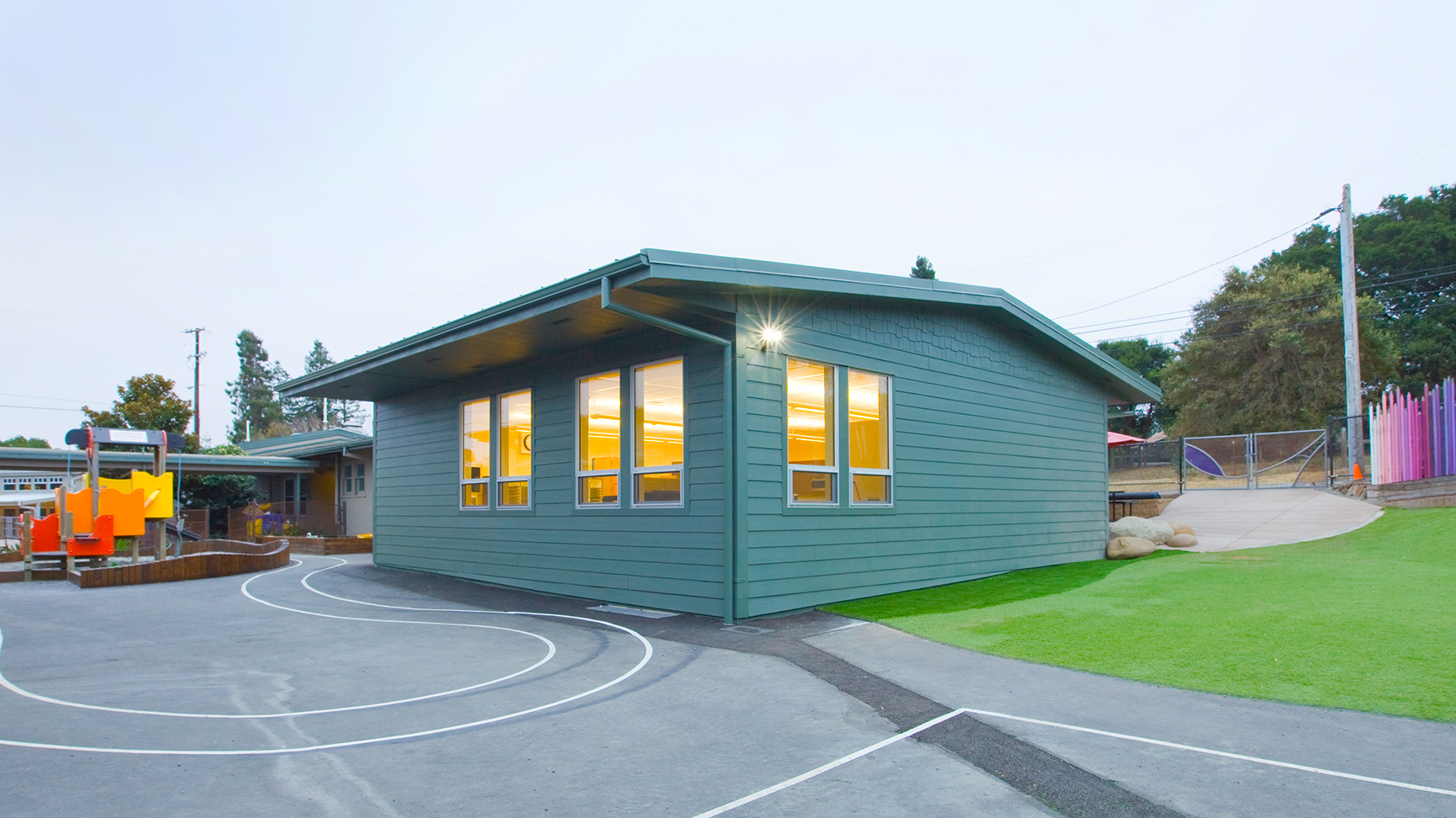 New portable classroom building with blue walls and bright, large windows.