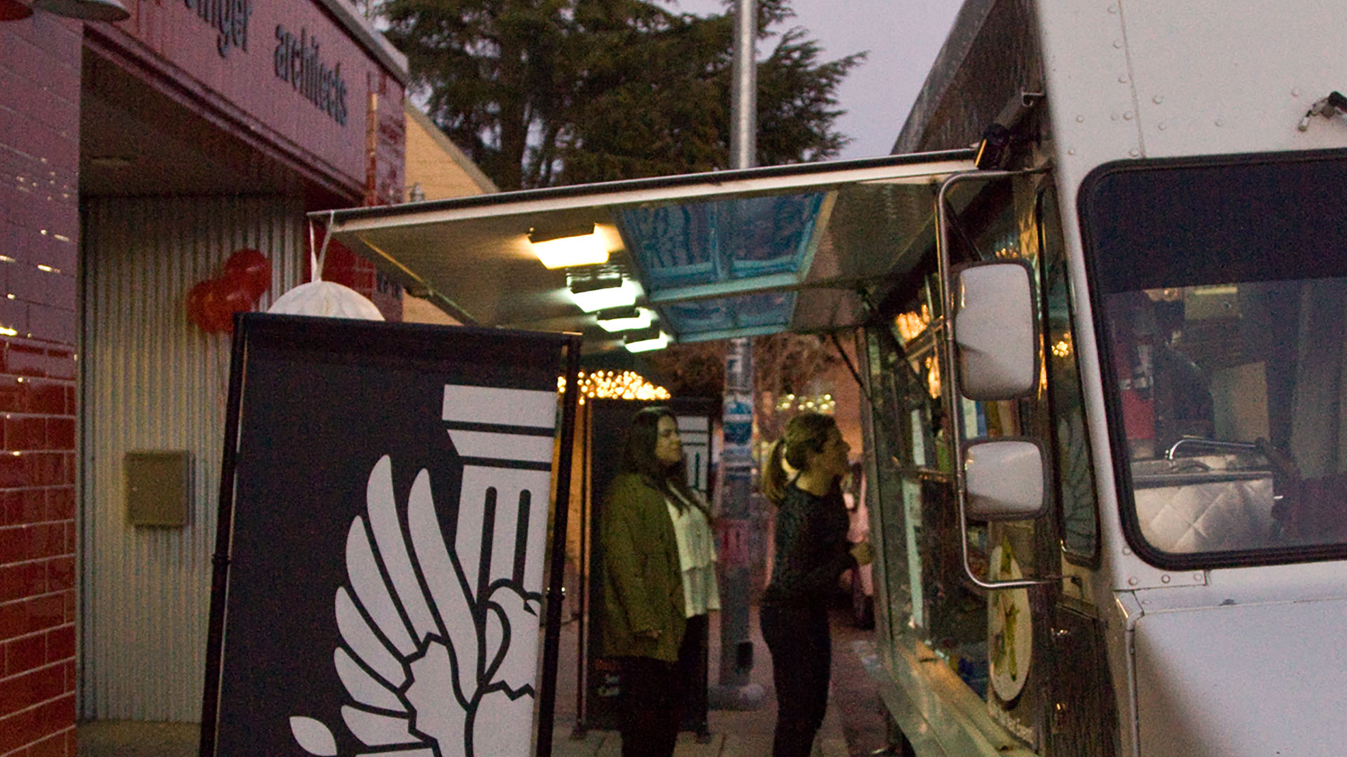 Food truck parked in front of Persinger Architects office, people lining up in front.