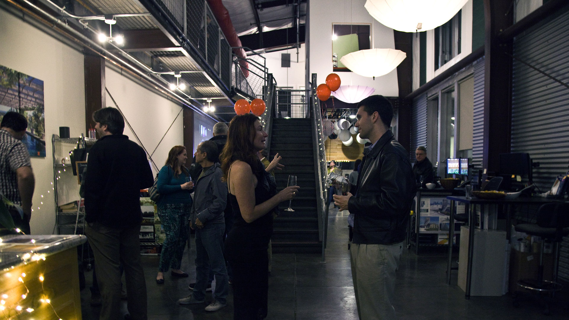 Pairs of people talking with office interior in background