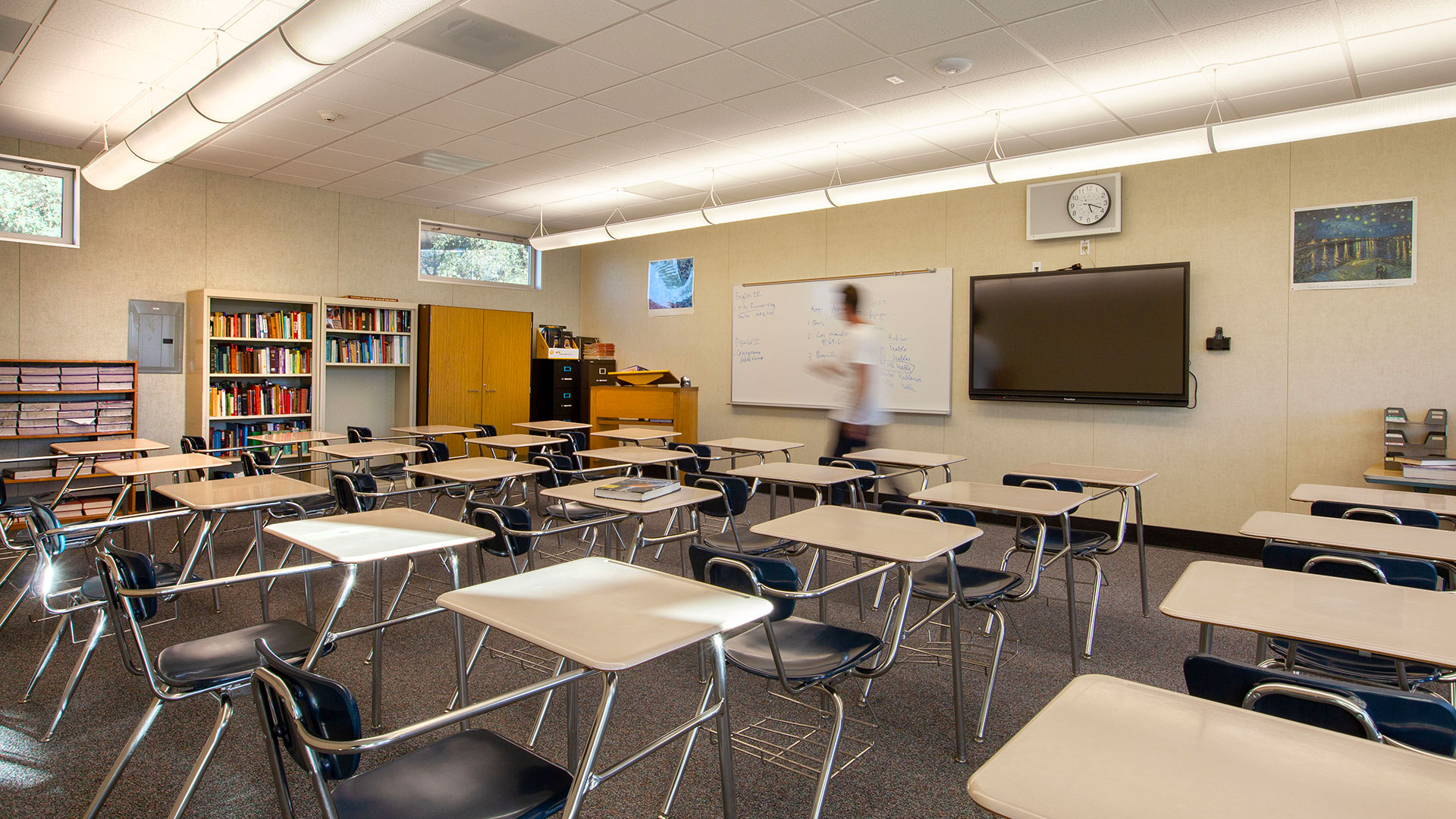 Interior of classroom with desks pointing towards teaching area
