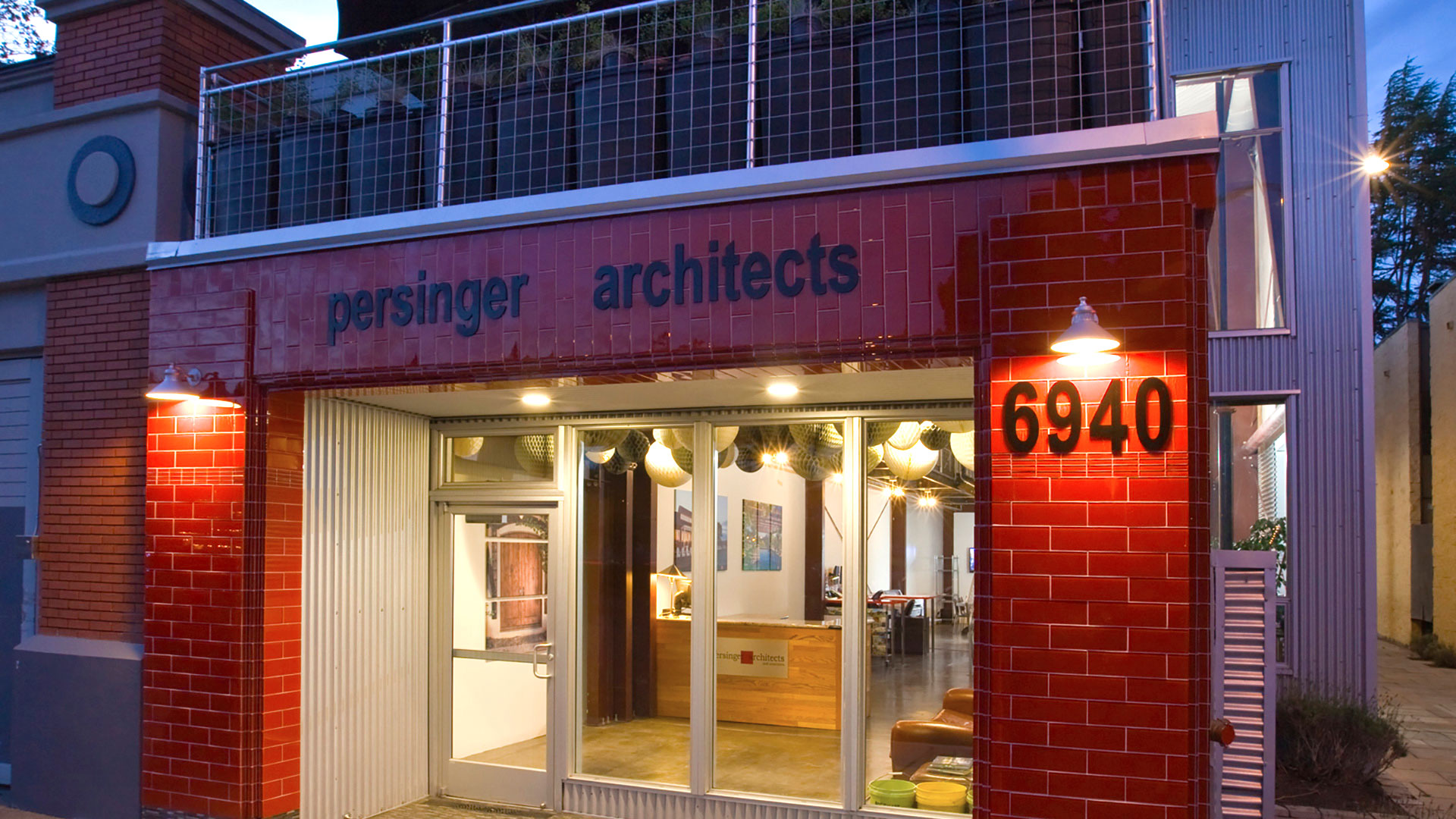 Office entrance at dusk, with bright office interior seen through large front window