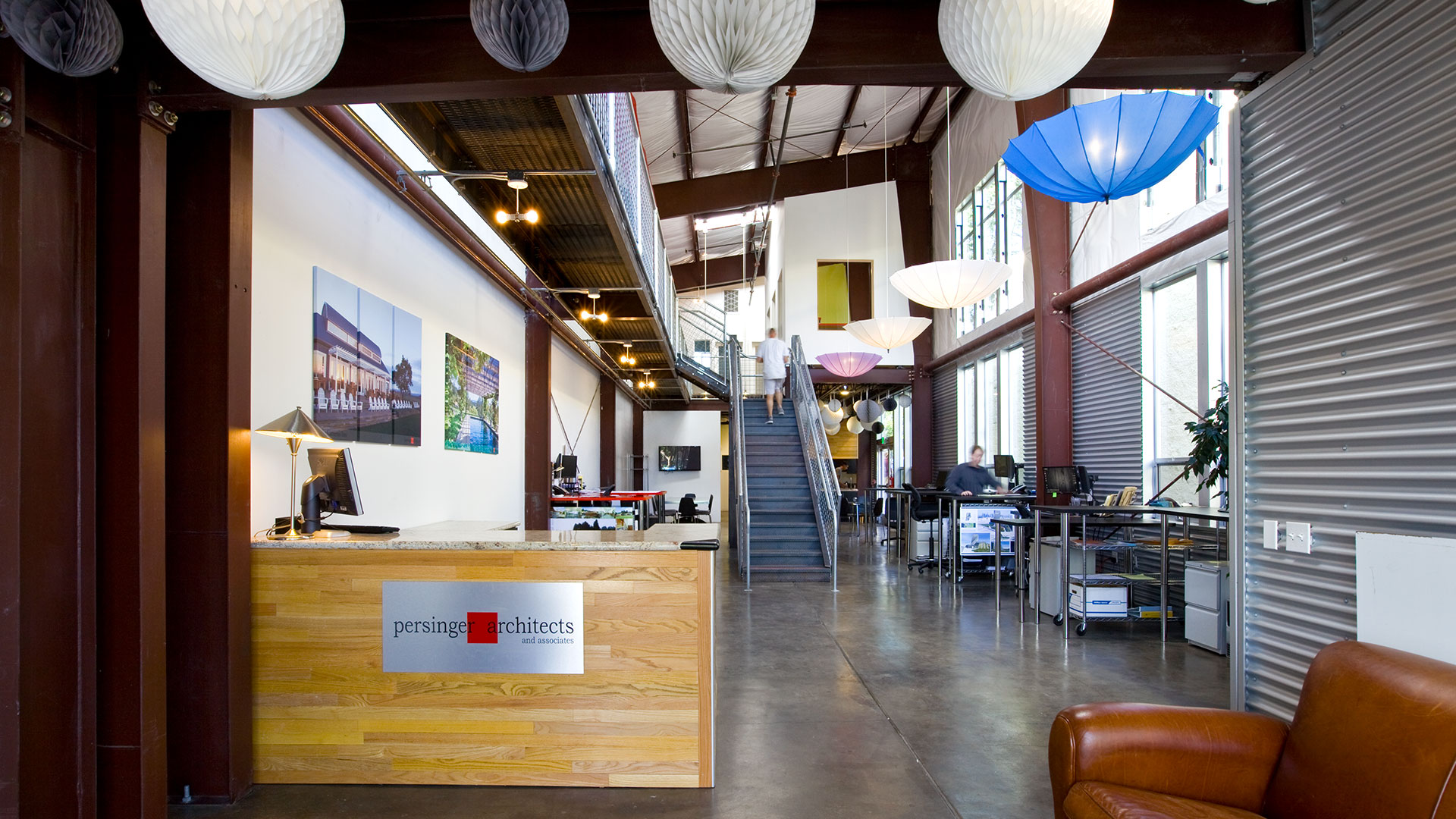 Interior of office, polished concrete floors and staircase in center,