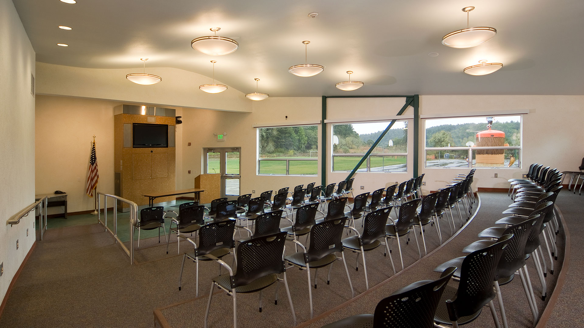 Interior classroom with desks arranged on a floor of various heights looking towards main teaching area.