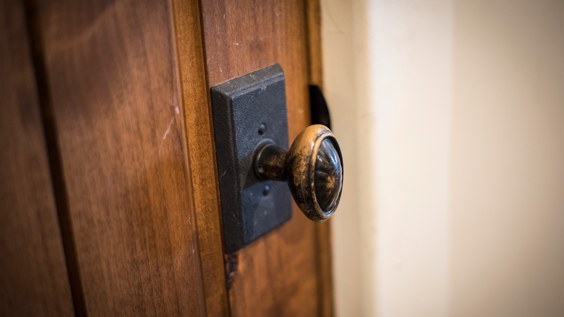 Closeup of door handle of rustic worn metal.