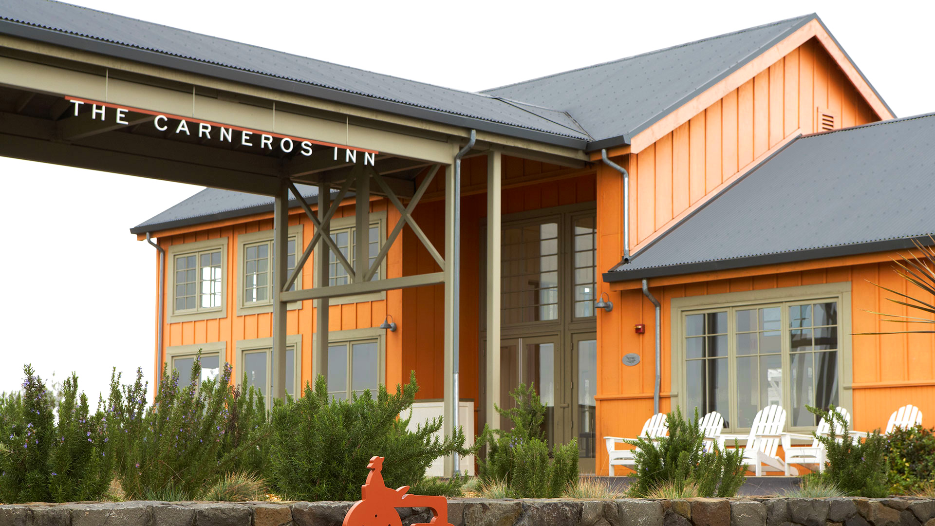 Two story height entrance for resort, orange with barn asthetic