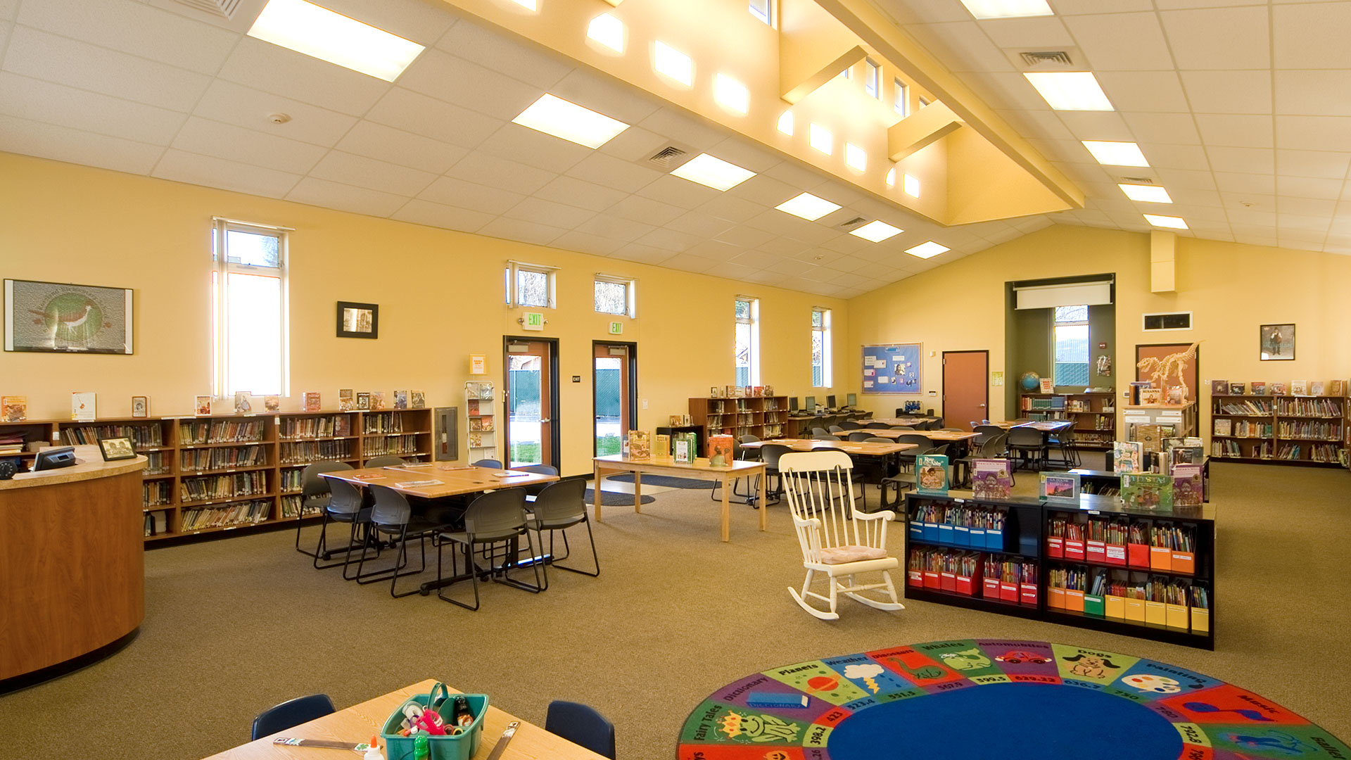 Library interior, yellow walls and bright, natural light from monitor above.