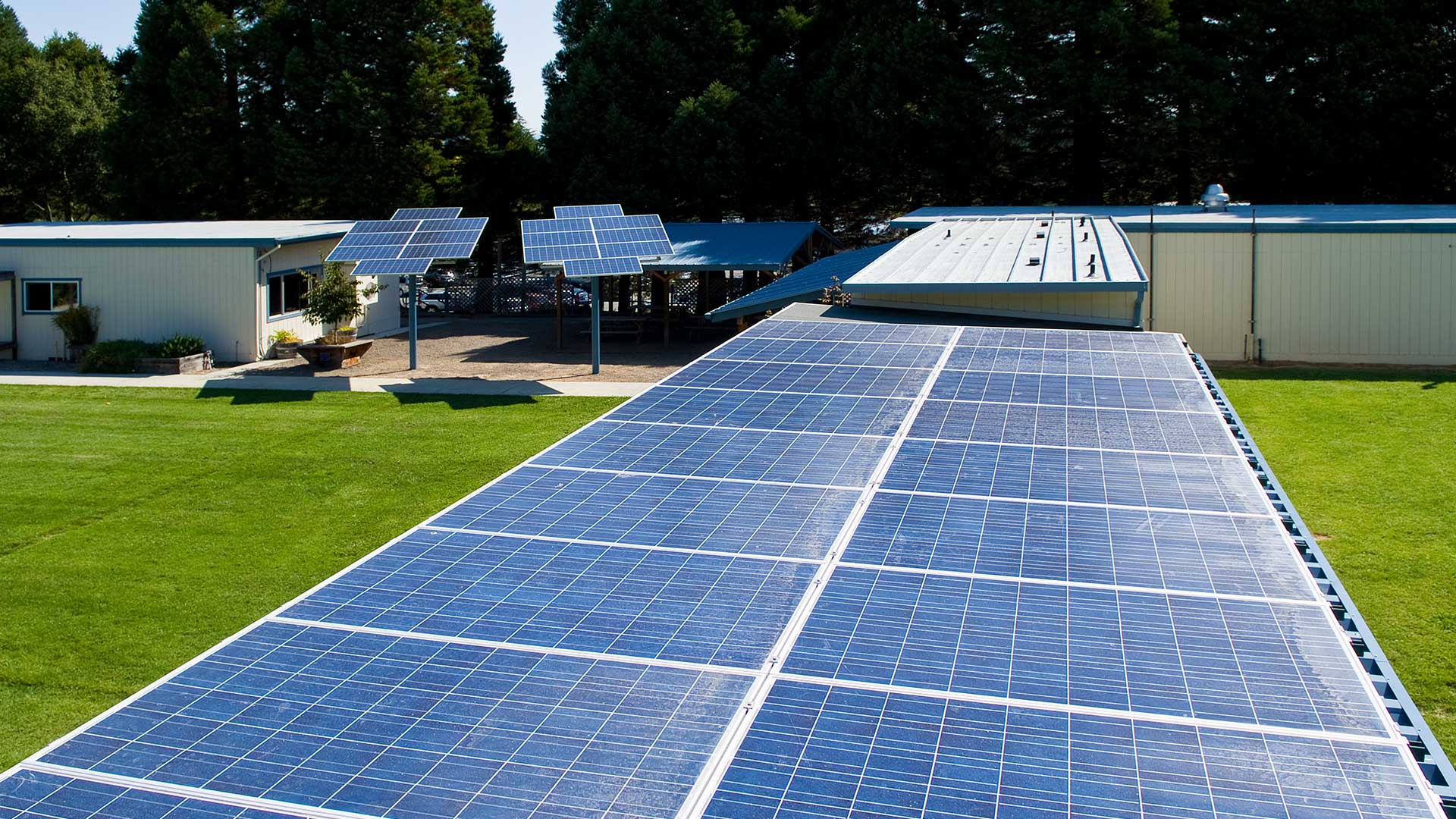 Walkways with extensive solar panels above, with 'solar sunflowers' installed behind.