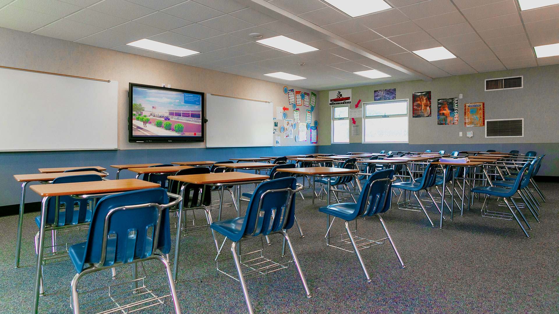 Renovated portable classroom interior, with bright windows, desks, and a teaching area.