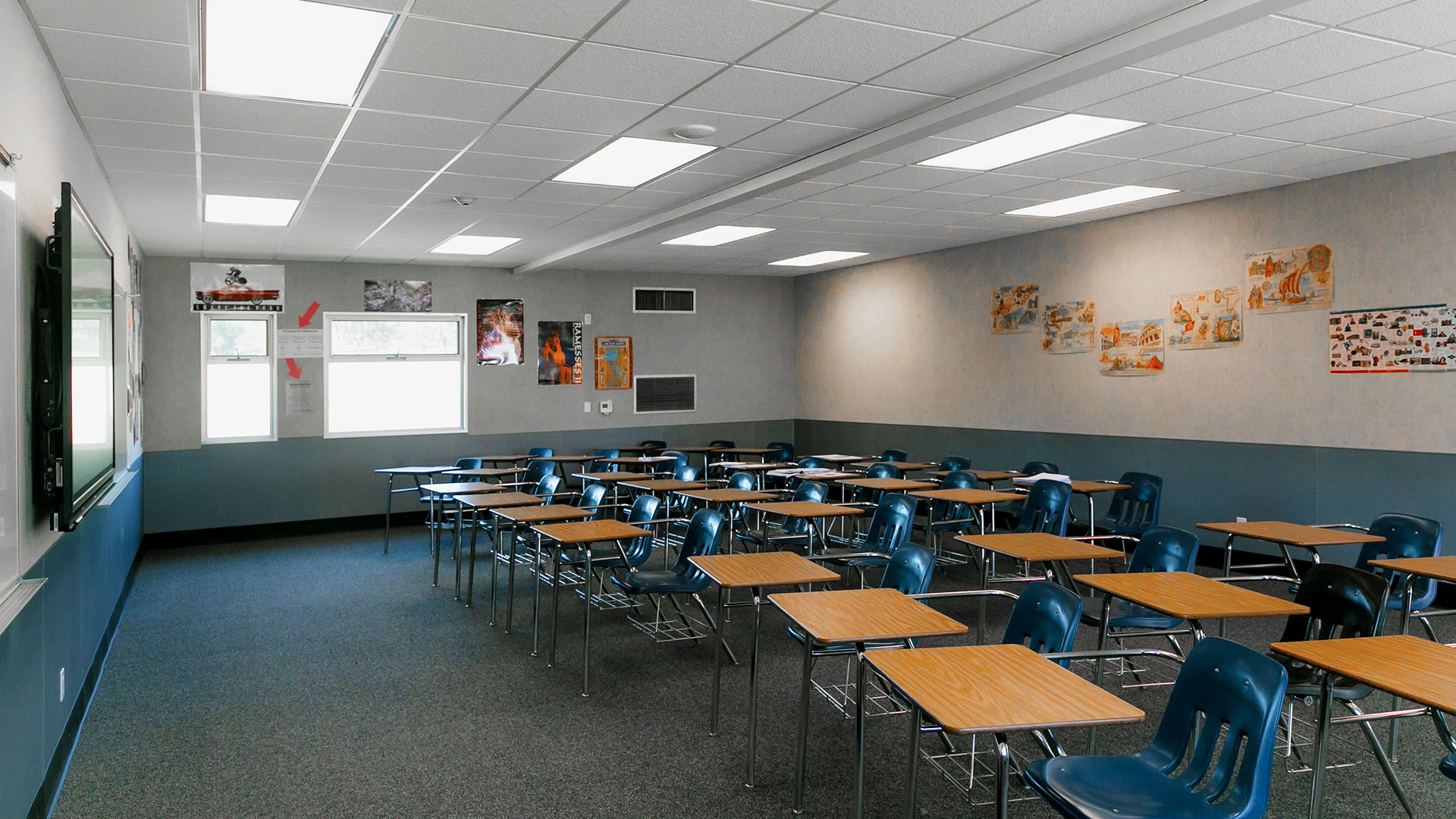 Renovated portable classroom interior, with bright windows, desks, and a teaching area.