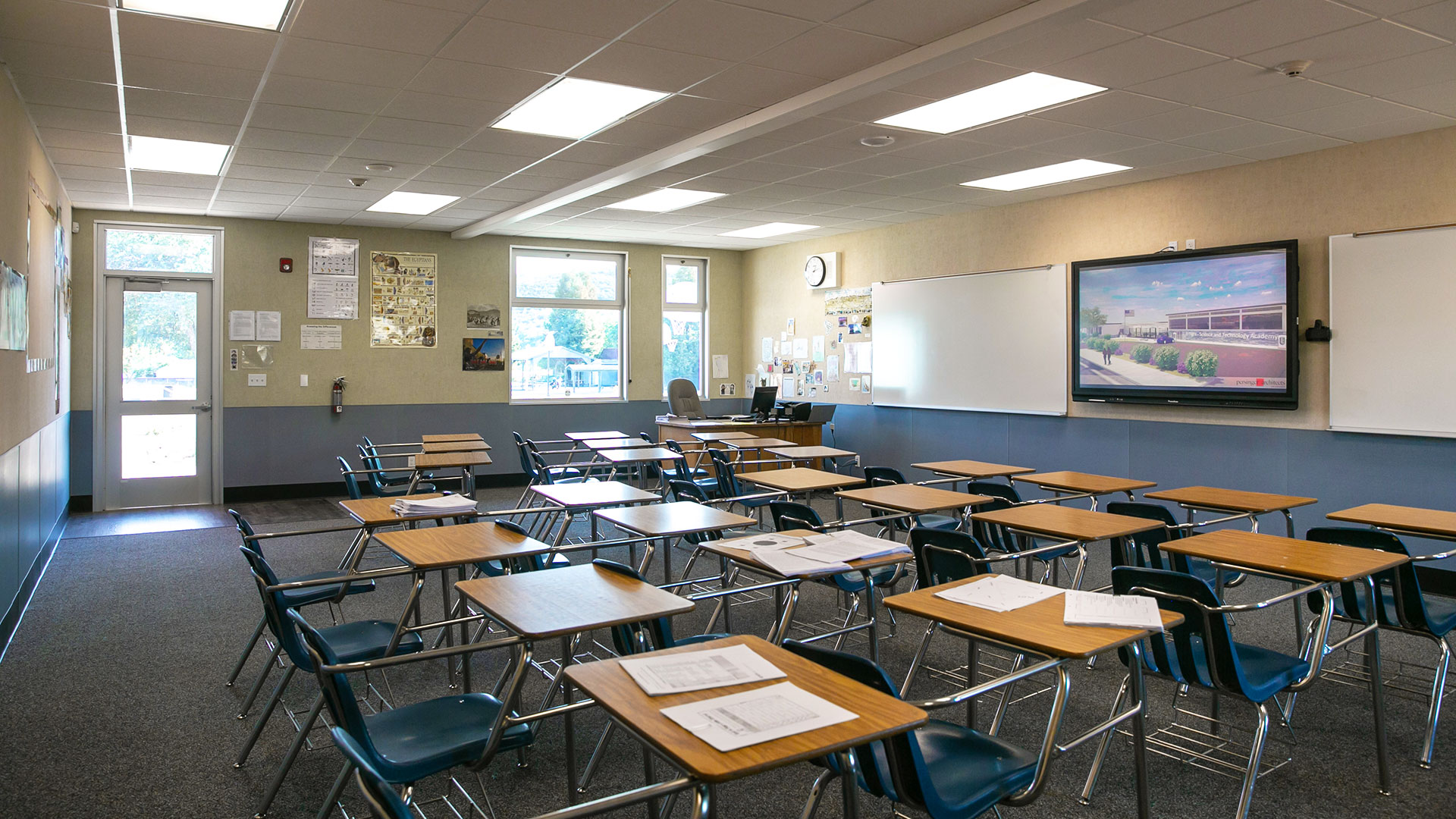 Renovated portable classroom interior, with bright windows, desks, and a teaching area.