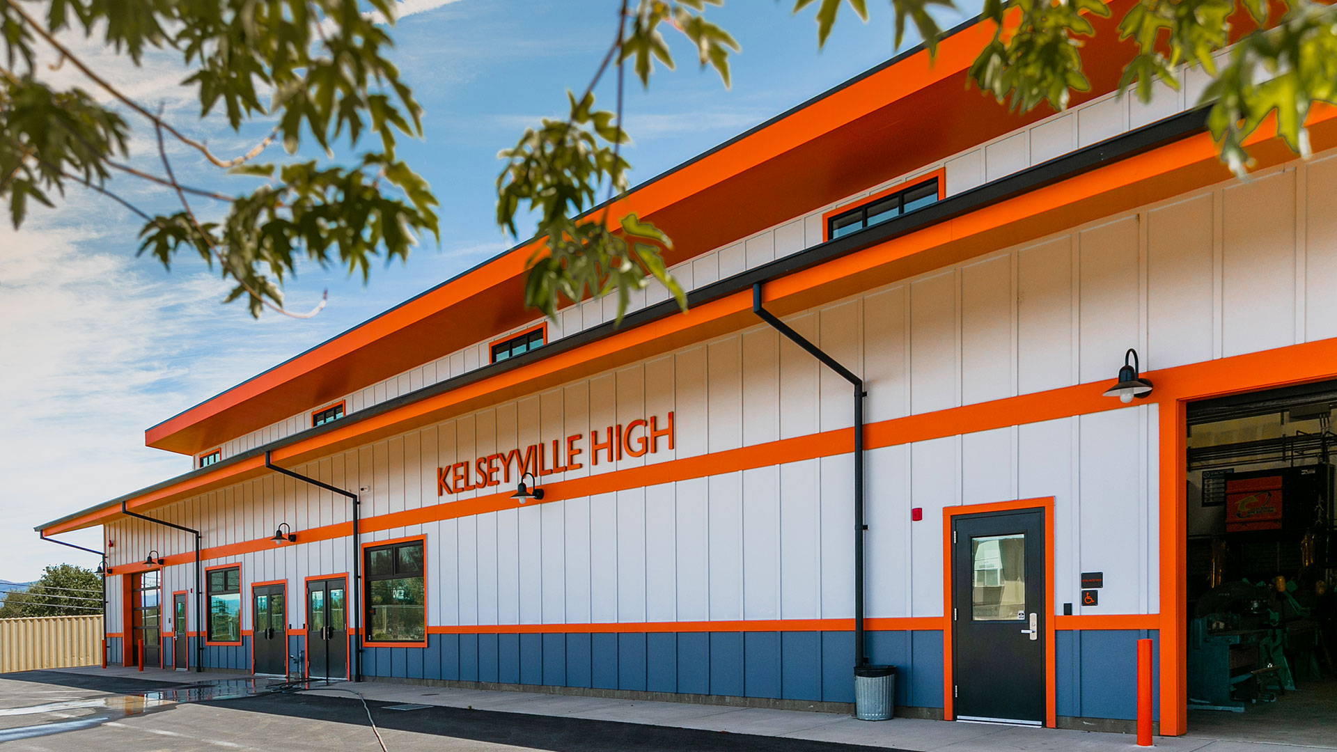 Orange and white shop exterior with leaves in the foreground.