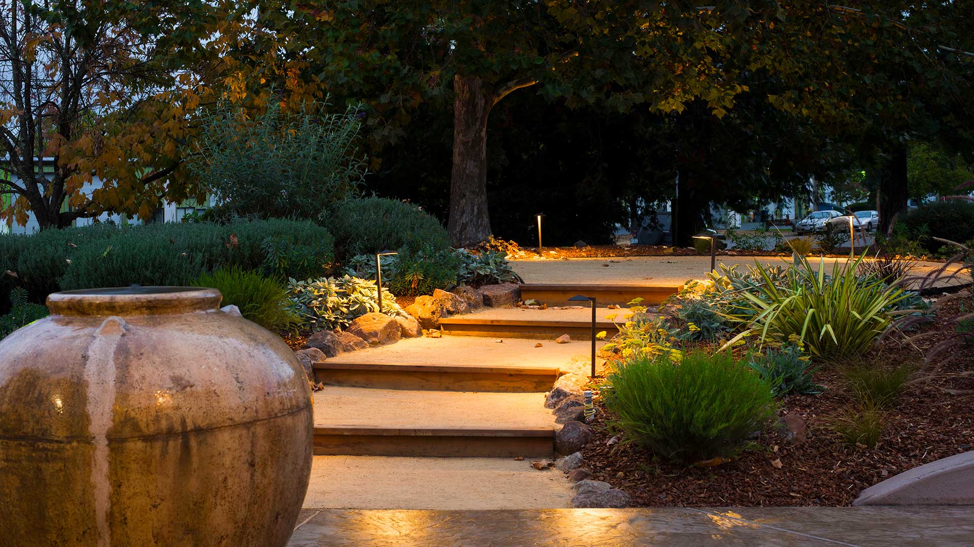 Outdoor of tasting room, garden with path and steps leading to seating area.