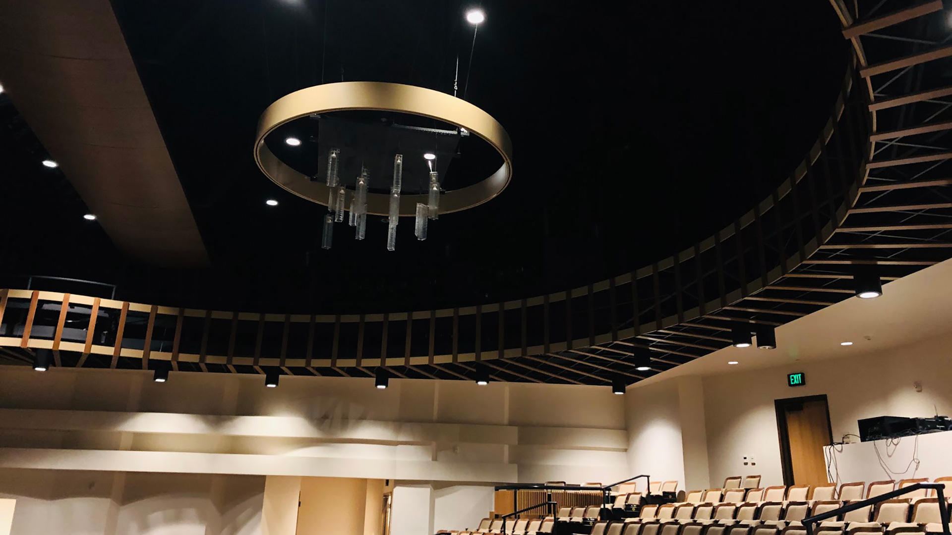 Auditorium with second floor seating and a large circular chandelier.