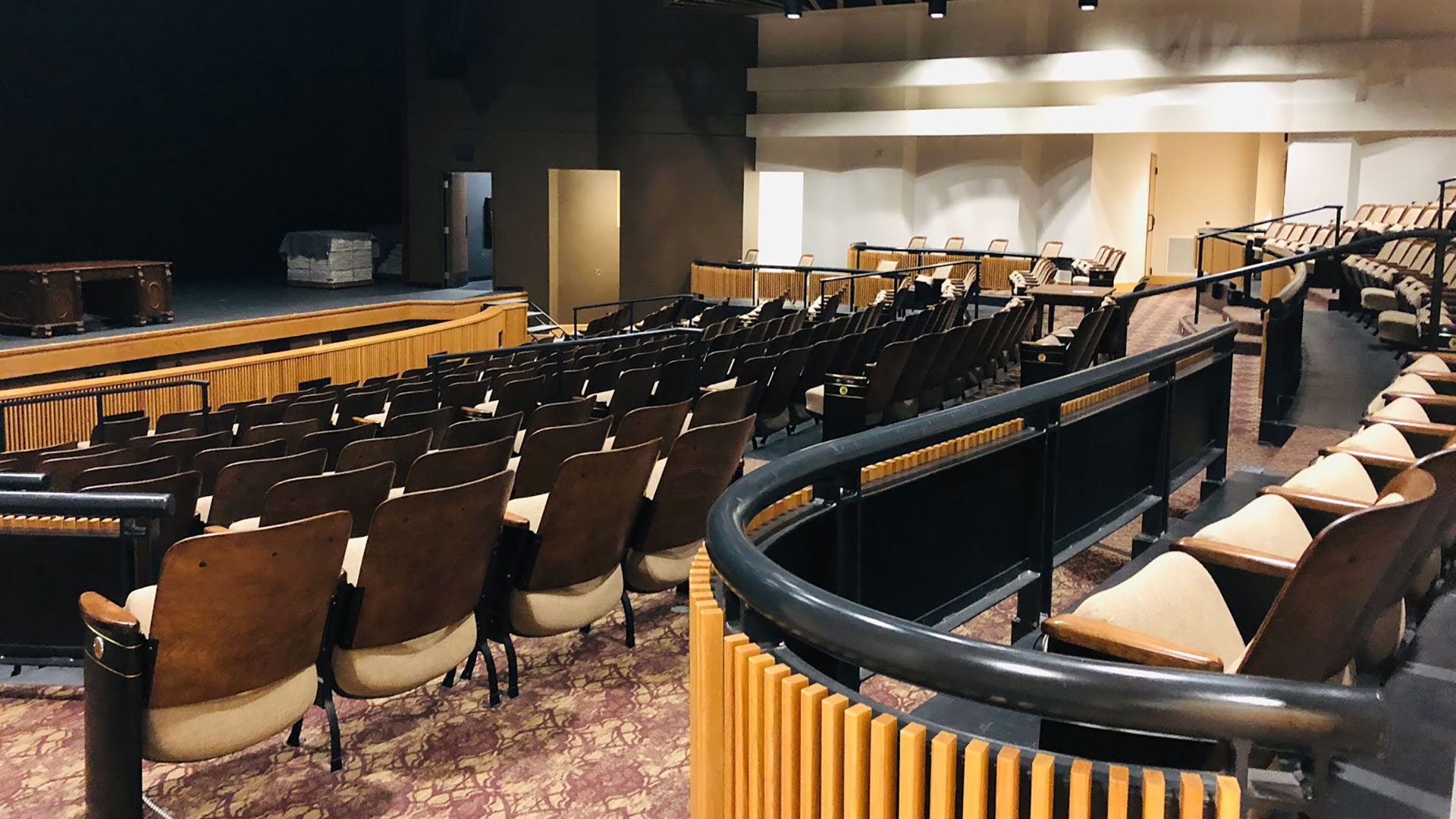 Closeup of wooden seating and curved railings of paneled wood