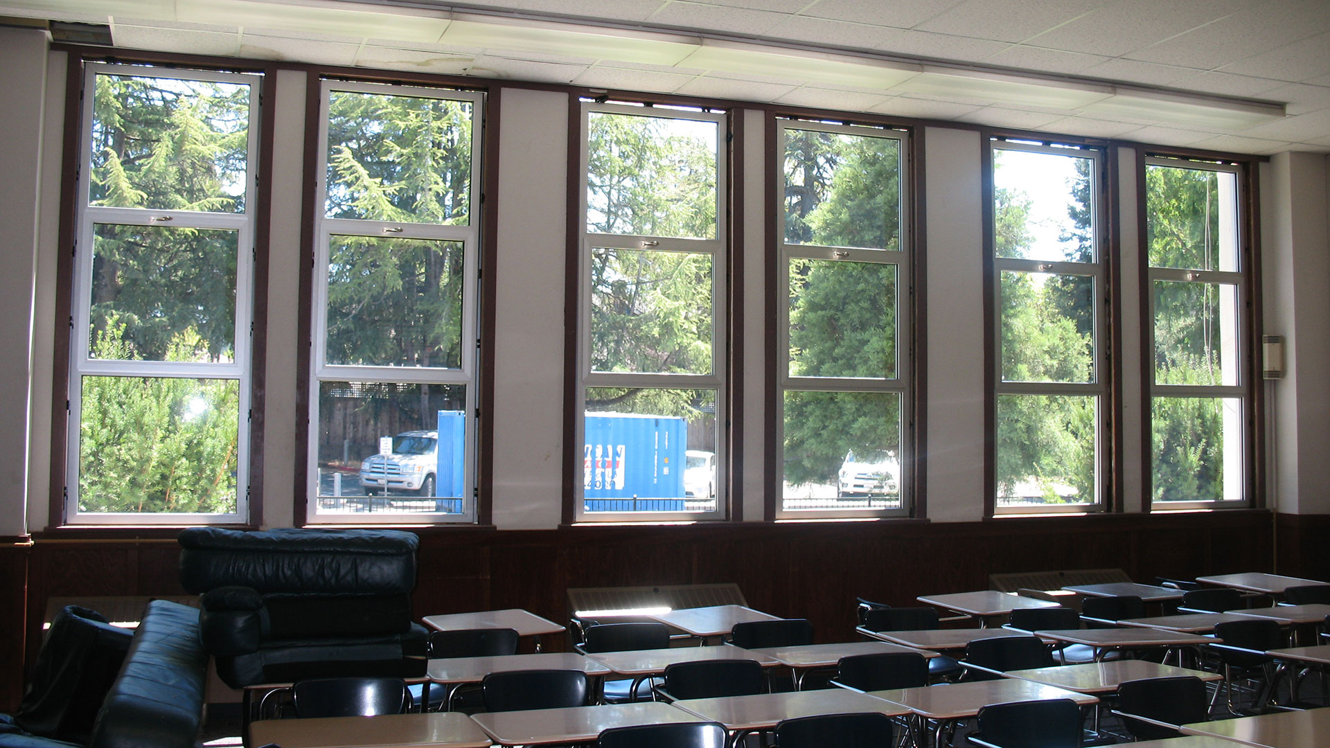 Interior of classroom with large, tall windows.
