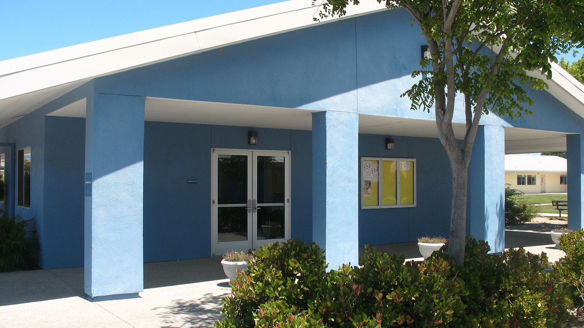 School building with blue walls and white trim.