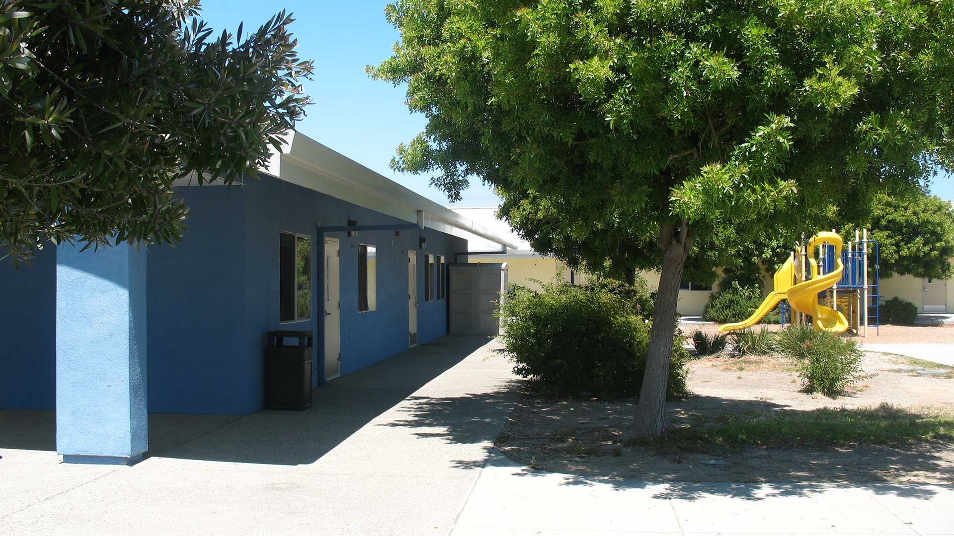 School building with blue walls and white trim.