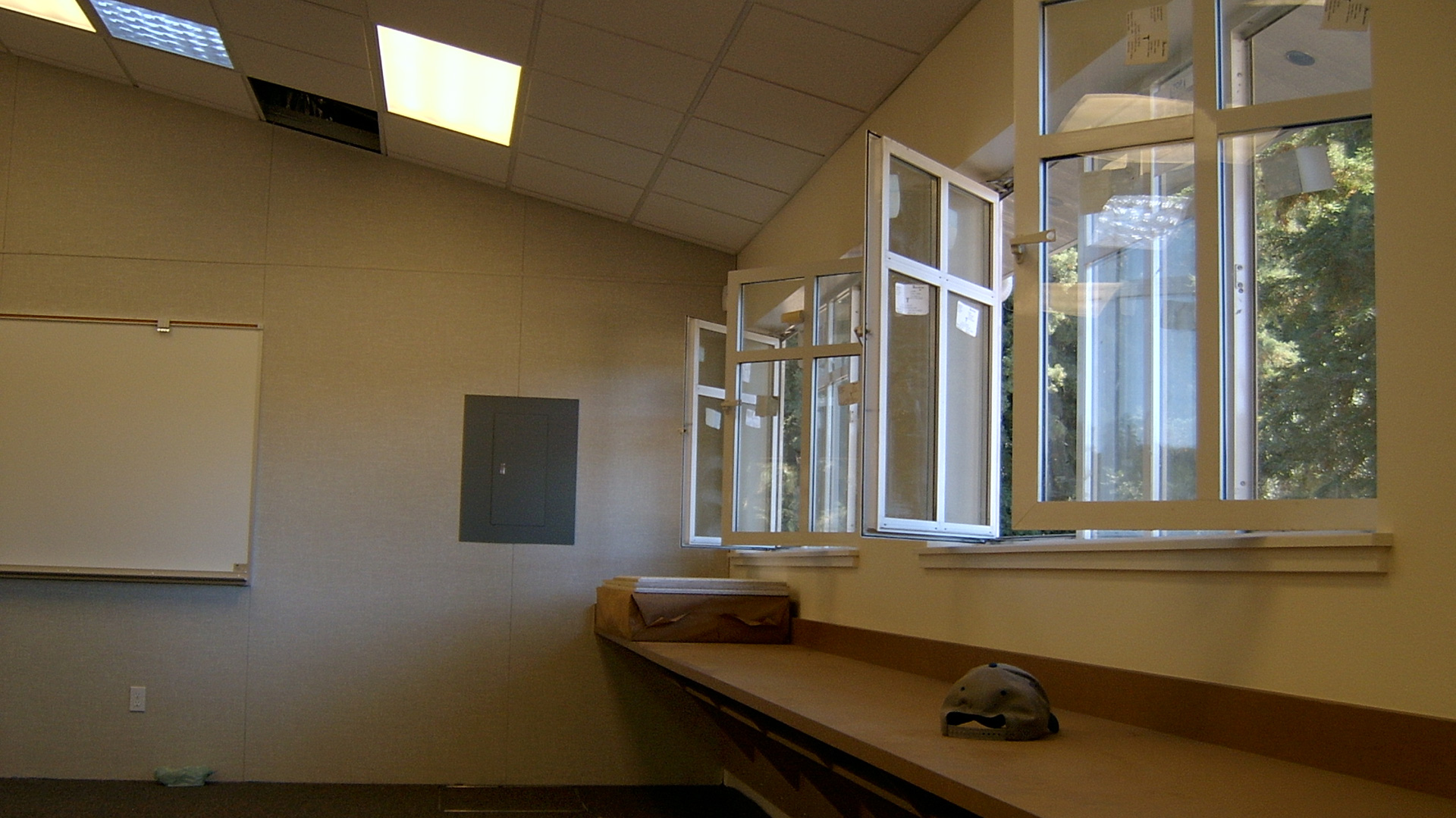 Interior of new classrooms, with vaulted ceilings, operable windows, and brown desks.