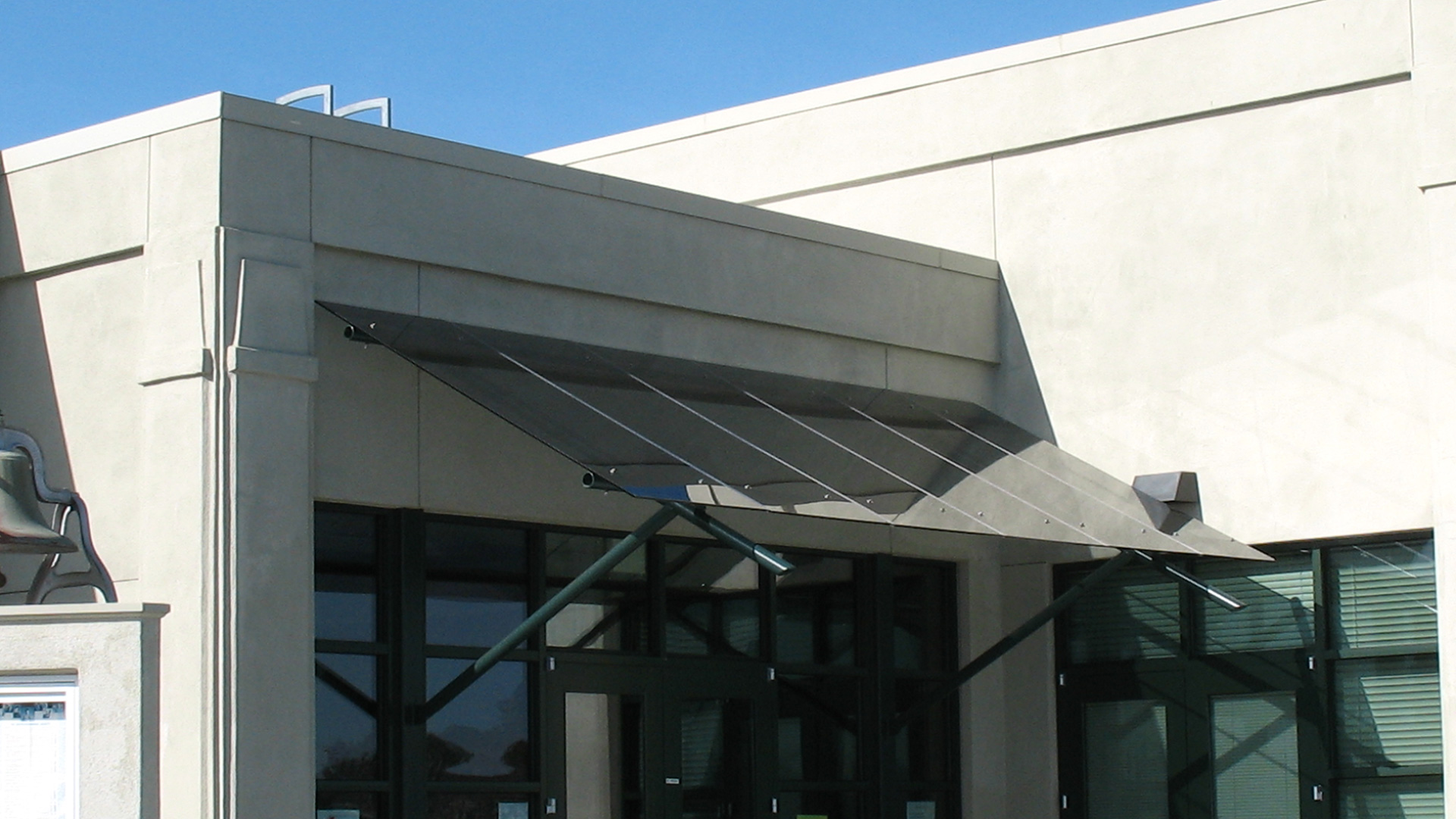 Entrance to district office, with glass awning above door.