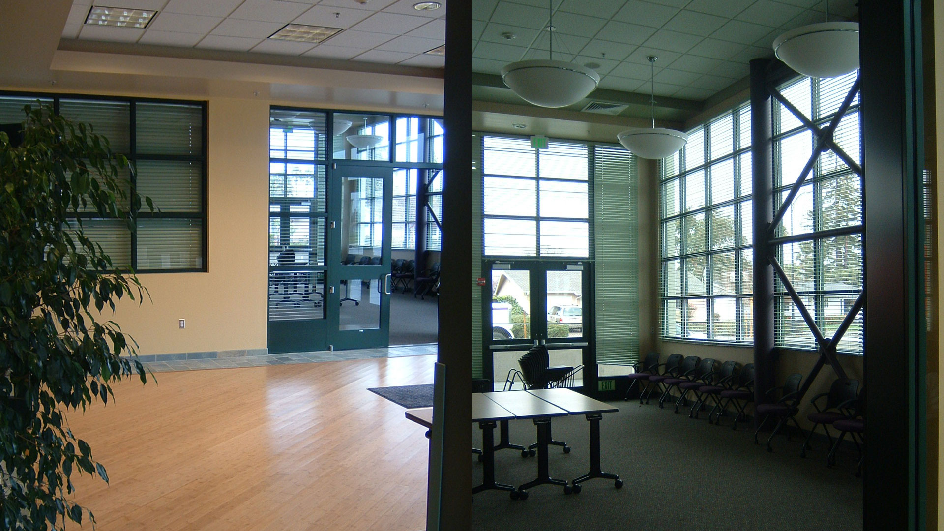 Interior of district office entrance with tall windows and glass double doors.