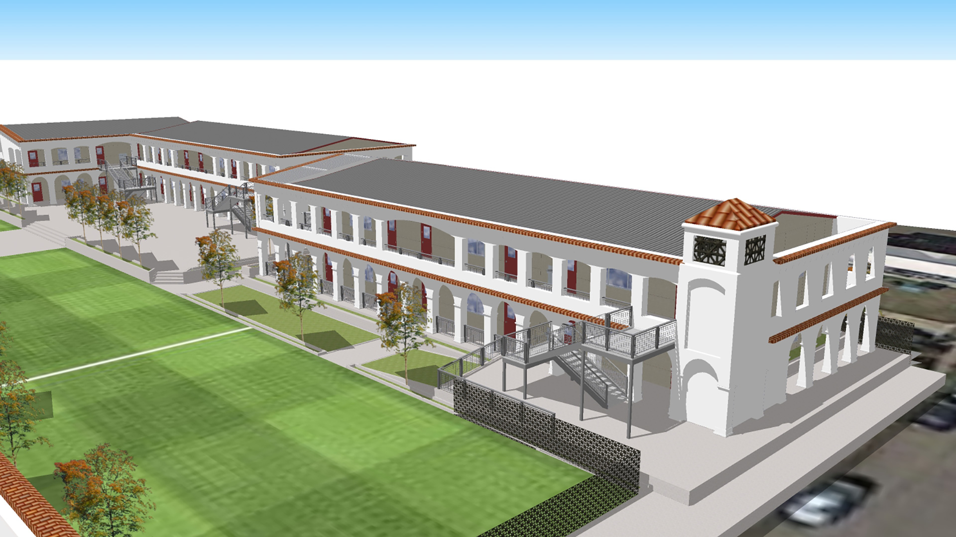 Render of mission-style classroom wing with two-stories and long hallways.