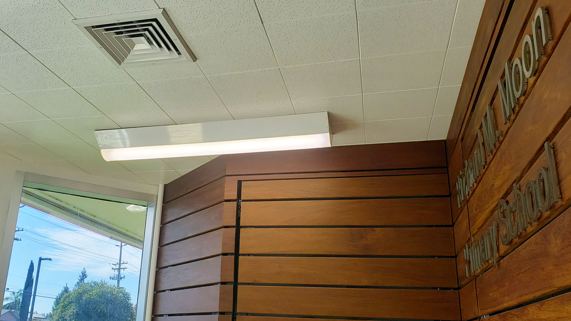 Constructed administrative foyer with wooden panel facade.