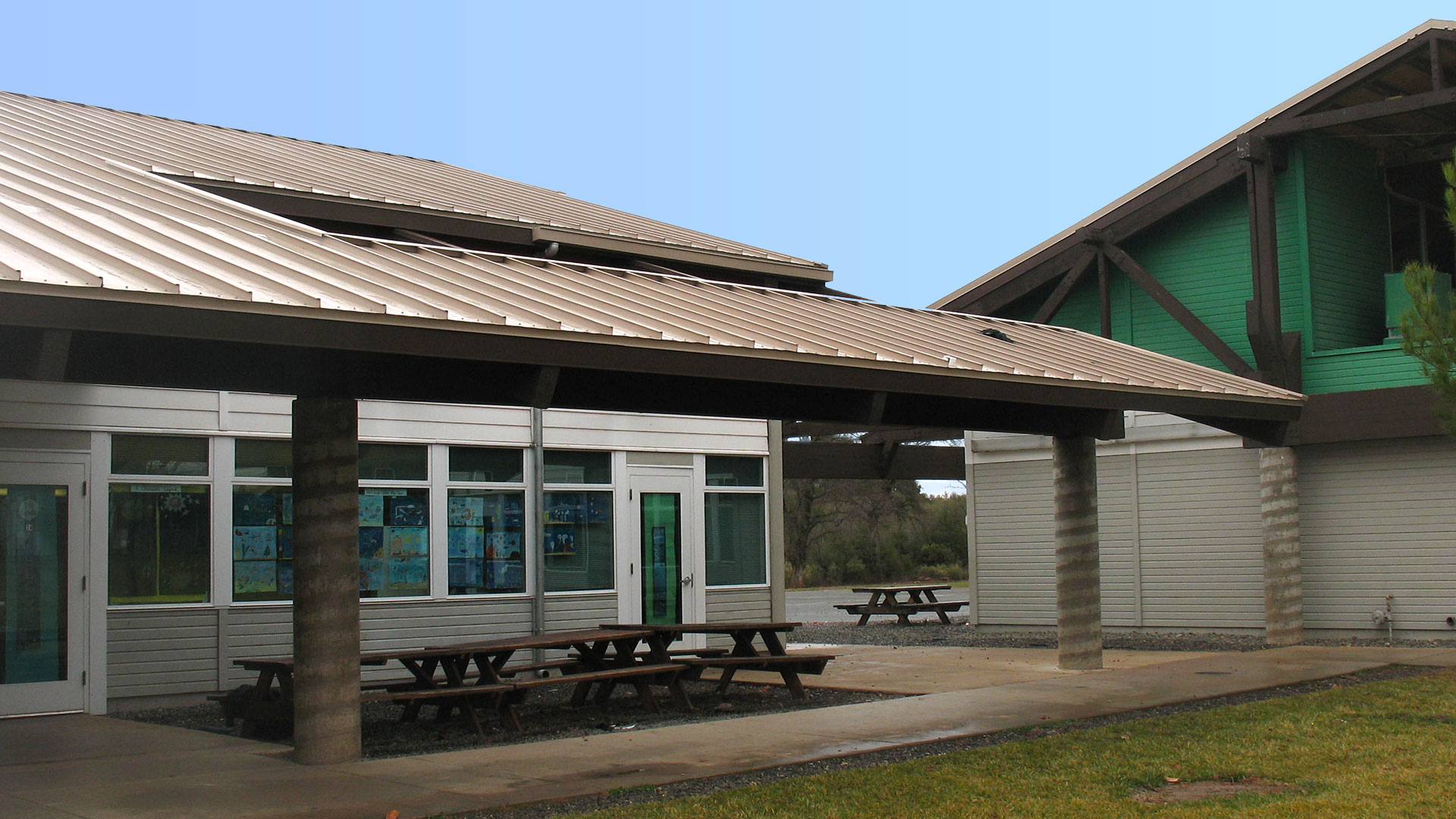 Section of building and overhand over seating area. Spiral columns hold up large sectioned roof.