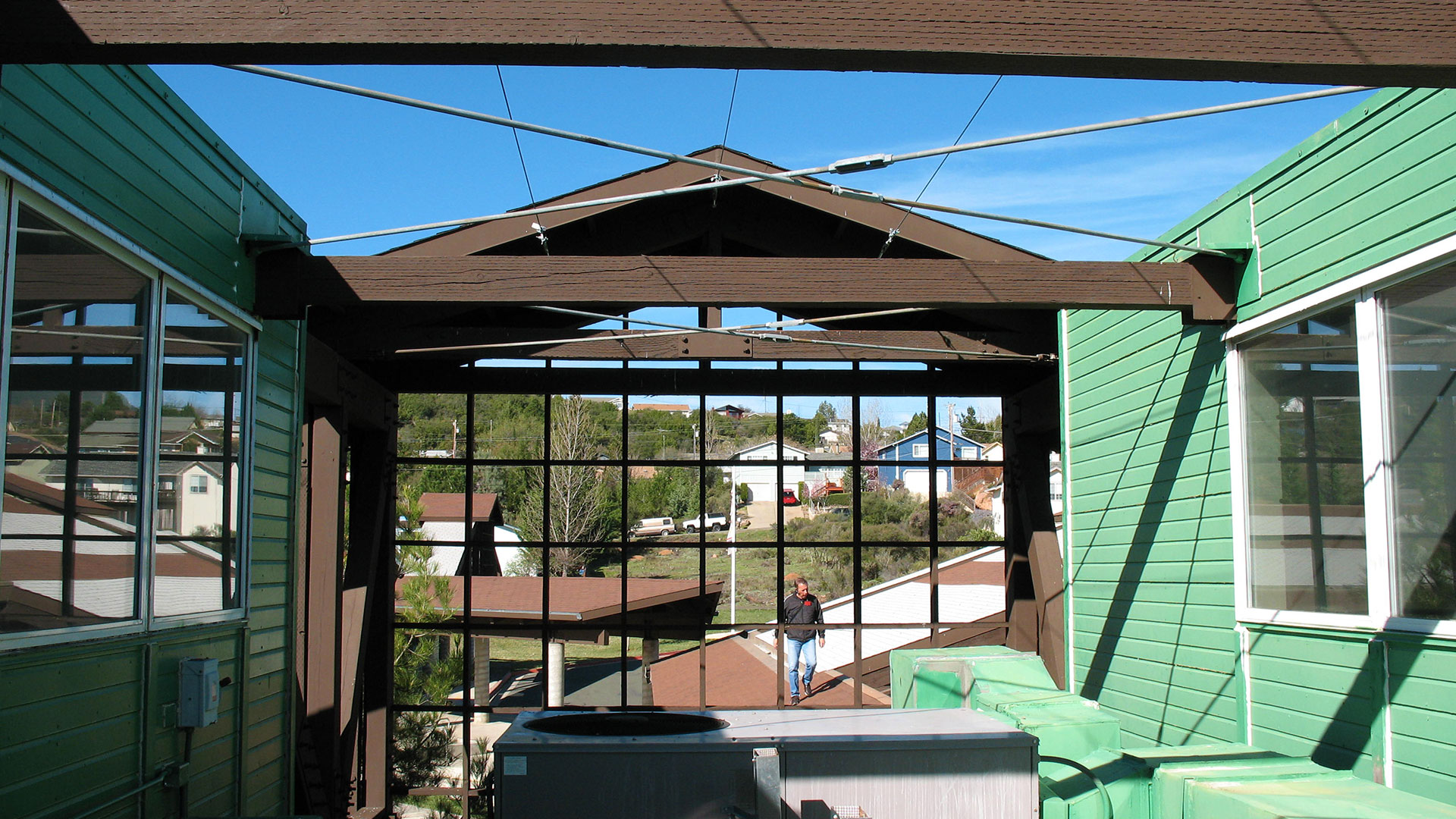 Area under the roof peak that is open to the sky, with a grate-like window looking down at campus.